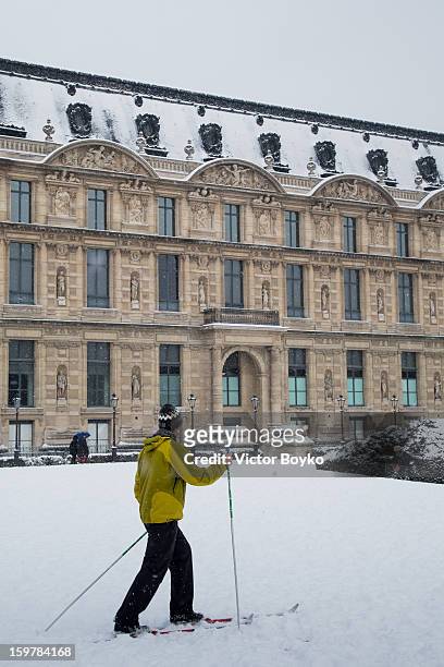 Man skiing at place du Caroussel with Musee du Louvre in the background on January 19, 2013 in Paris, France. Heavy snowfall fell throughout Europe...