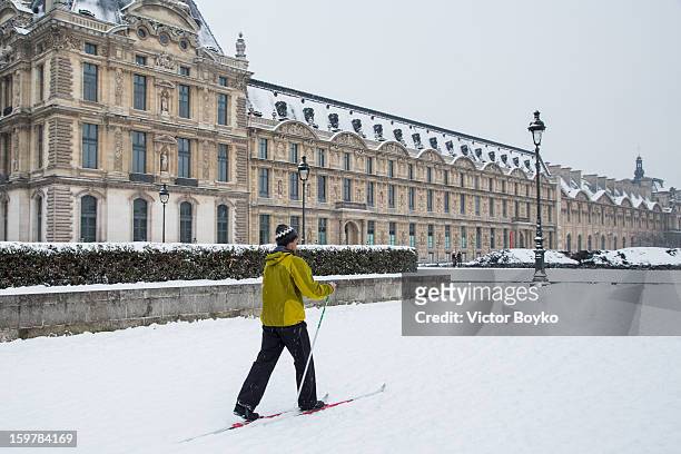 Man skiing at place du Caroussel with Musee du Louvre in the background on January 19, 2013 in Paris, France. Heavy snowfall fell throughout Europe...