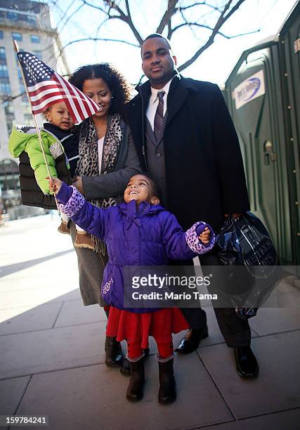Ariana Smith holds an American flag as mother Ana Blanco-Smith carries Christian Smith and father Grasford Smith poses during preparations for U.S....