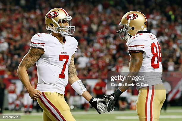 Quarterback Colin Kaepernick and wide receiver Randy Moss of the San Francisco 49ers celebrate after Kaepernick throws a touchdown pass to tight end...