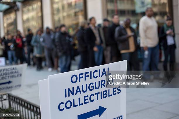 People wait ina line that snakes down the street at the entrance to the official inauguration merchandise store January 20, 2013 in Washington D.C....