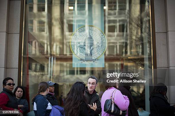 People wait ina line that snakes down the street at the entrance to the official inauguration merchandise store January 20, 2013 in Washington D.C....