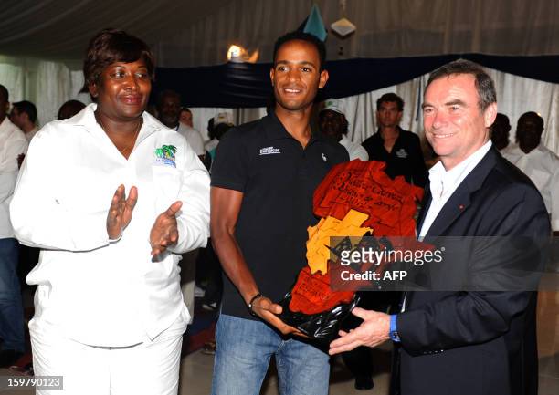 Eritrean Natnael Berhane receives the African Cyclist of the year 2012 trophy from French Bernard Hinault , five-times Tour de France champion, at...