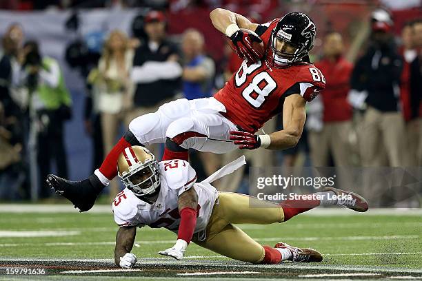 Tight end Tony Gonzalez of the Atlanta Falcons is tackled by cornerback Tarell Brown of the San Francisco 49ers in the third quarter in the NFC...