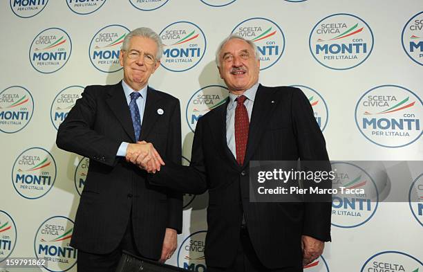 Italian Prime Minister Mario Monti shakes hands Alberto Bombassei during a convention for his centrist alliance 'With Monti For Italy' at Kilometro...