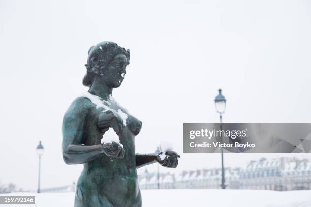 Statue covered with snow on January 20, 2013 in Paris, France. Heavy snowfall fell throughout Europe and the UK causing travel havoc and white layers...