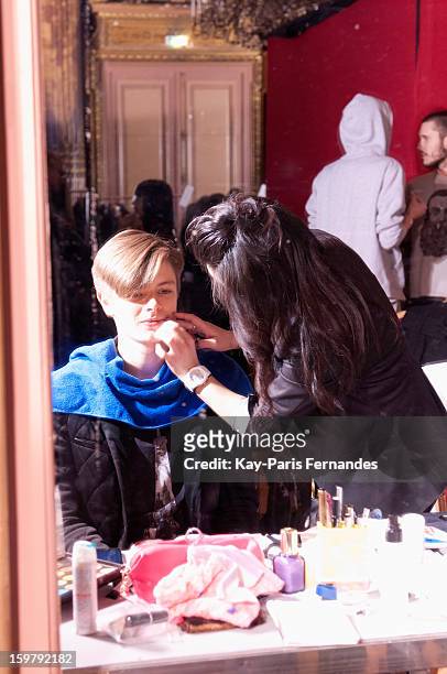 Model has his make-up done backstage during the Rynshu Men Autumn / Winter 2013 show as part of Paris Fashion Week on January 20, 2013 in Paris,...