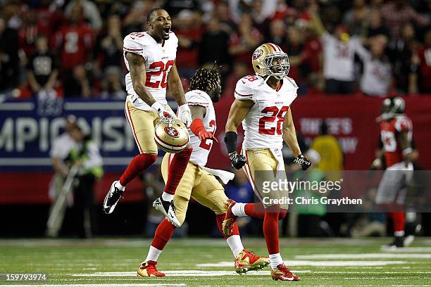 Perrish Cox, Anthony Dixon and Darcel McBath of the San Francisco 49ers react after stopping the Atlanta Falcons on fourth down in the fourth quarter...