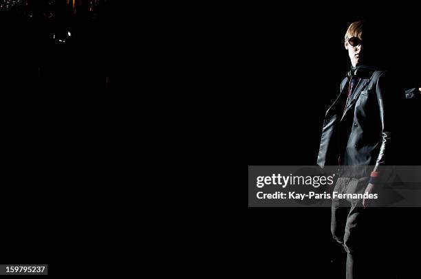 Model walks the runway before the Rynshu Men Autumn / Winter 2013 show as part of Paris Fashion Week on January 20, 2013 in Paris, France.