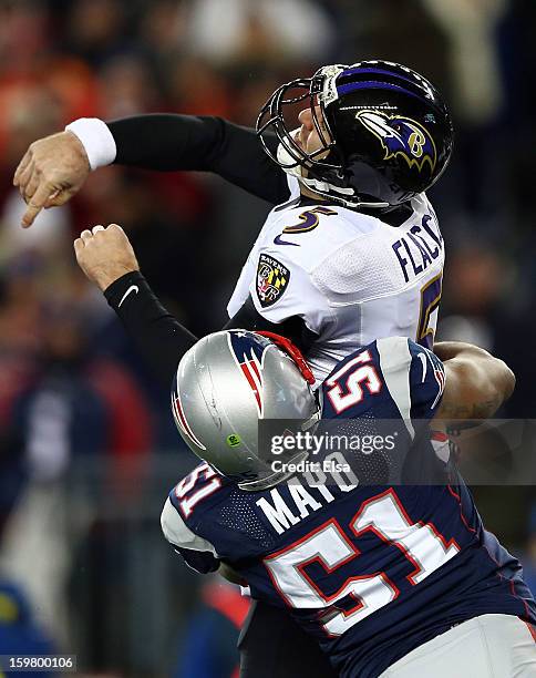 Joe Flacco of the Baltimore Ravens gets tackled after a throw against Jerod Mayo of the New England Patriots during the 2013 AFC Championship game at...