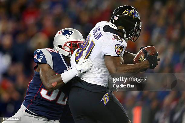 Anquan Boldin of the Baltimore Ravens scores a touchdown passed by Joe Flacco in the fourth quarter against Devin McCourty of the New England...