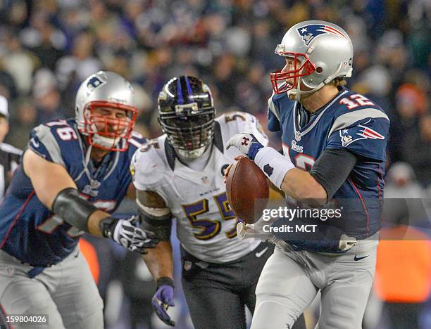 New England Patriots quarterback Tom Brady runs from the pocket to escape the oncoming pressure of Baltimore Ravens outside linebacker Terrell Suggs...