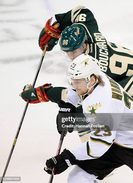 Tom Wandell of the Dallas Stars and Pierre-Marc Bouchard of the Minnesota Wild skate after a puck during the first period of the game on January 20,...