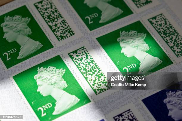 Books of barcoded Royal Mail 2nd class postage stamps depicting the head of Queen Elizabeth II on 29th July 2023 in St Dogmaels, Wales, United...