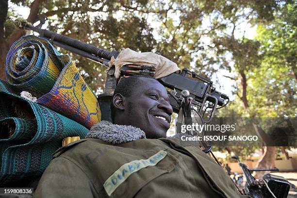 Malian soldiers deployed to the city of Niono look on January 19, 2013. Ivorian President Alassane Ouattara on January 19 called for a broader...