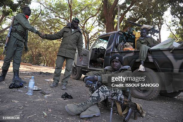 Malian soldiers deployed to the city of Niono look on January 19, 2013. Ivorian President Alassane Ouattara on January 19 called for a broader...