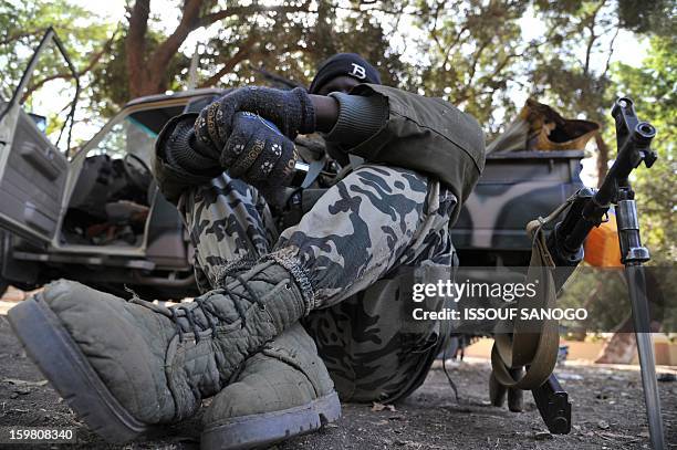 Malian soldiers deployed to the city of Niono look on January 19, 2013. Ivorian President Alassane Ouattara on January 19 called for a broader...