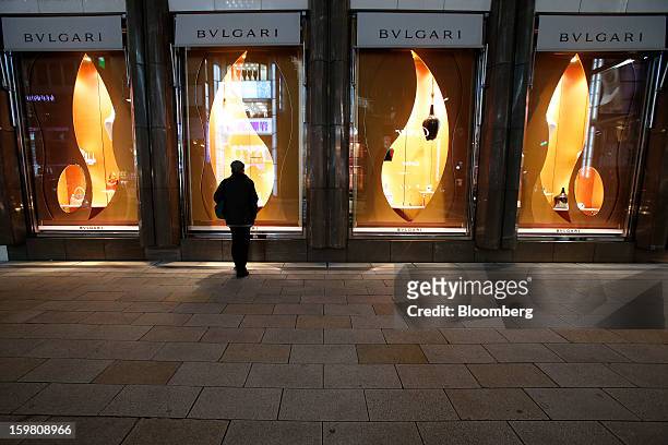 Man looks through the window of a Bulgari SpA store, a luxury unit of LVMH Moet Hennessy Louis Vuitton SA, in the Ginza district of Tokyo, Japan, on...