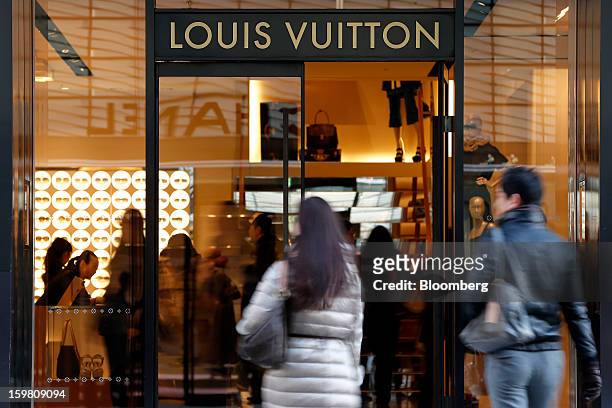 Customers enter a Louis Vuitton store, operated by LVMH Moet Hennessy Louis Vuitton SA, in the Ginza district of Tokyo, Japan, on Sunday, Jan. 20,...