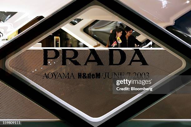 Customers are viewed through a window as they browse goods inside a Prada SpA store in the Omotesando district of Tokyo, Japan, on Saturday, Jan. 19,...