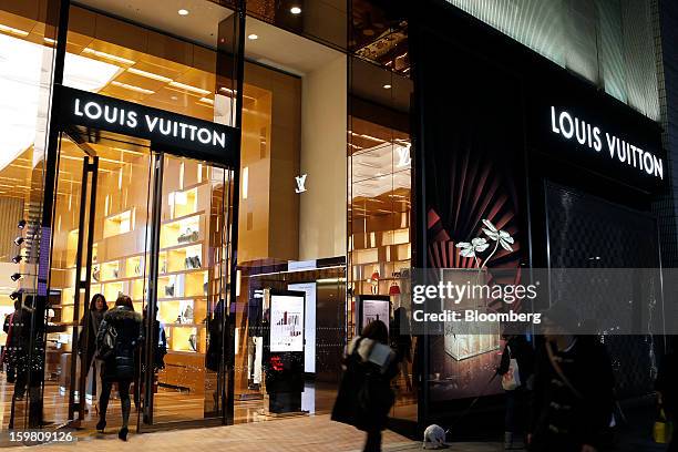 Pedestrians walk past a Louis Vuitton store, operated by LVMH Moet Hennessy Louis Vuitton SA, in the Omotesando district of Tokyo, Japan, on...