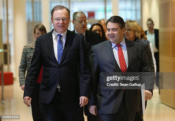 Stephan Weil, gubernatorial candidate in Lower Saxony for the German Social Democrats , and SPD Chairman Sigmar Gabriel arrive to speak to reporters...