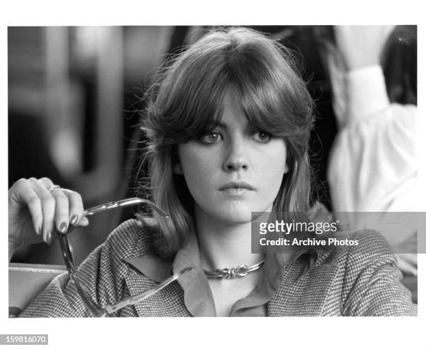 Lynne Frederick holding her glasses in a scene from the film 'Schizo', 1976.