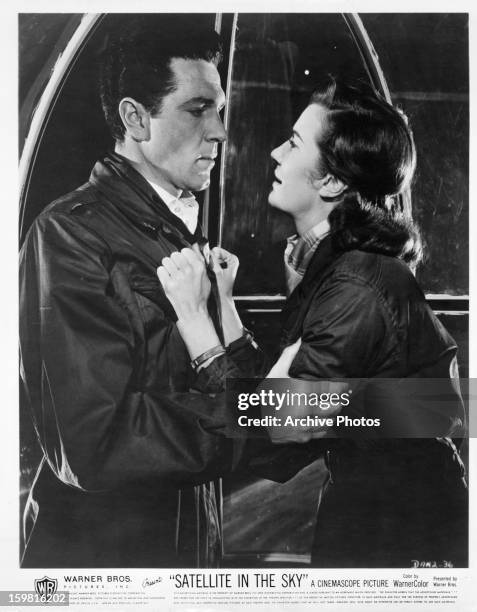 Kieron Moore and Lois Maxwell having an intense moment in a scene from the film 'Satellite in the Sky', 1956.