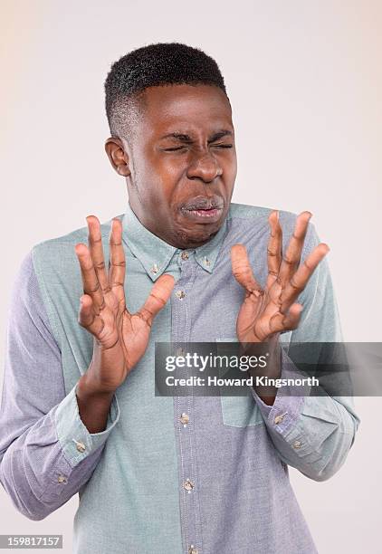 twisted faces - repugnancia fotografías e imágenes de stock