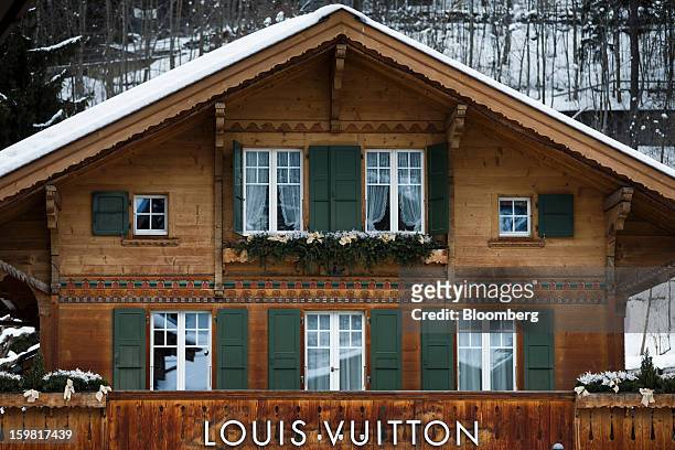 Louis Vuitton logo sits above a store, and beneath the balcony of a Swiss chalet in Gstaad, Switzerland, on Saturday, Jan. 19, 2013. Options traders...