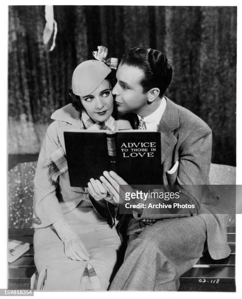 Ruby Keeler is kissed on the cheek by Dick Powell in a scene from the film 'Gold Diggers Of 1933', 1933.