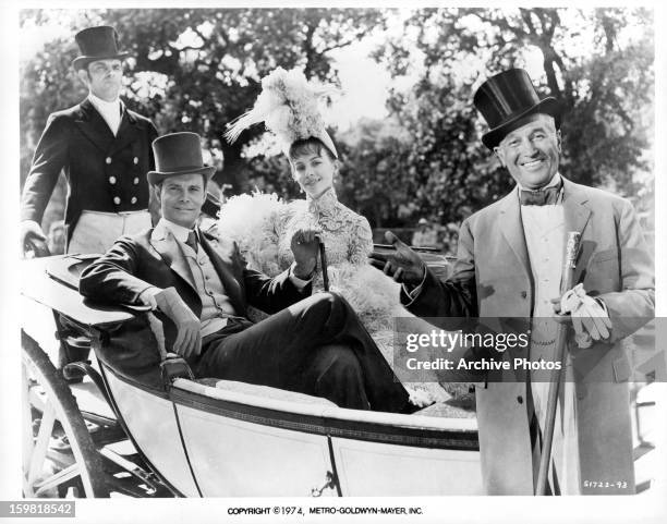 Louis Jourdan and Leslie Caron in carriage with a smiling Maurice Chevalier in front of them in publicity portrait for the film 'Gigi', 1958.