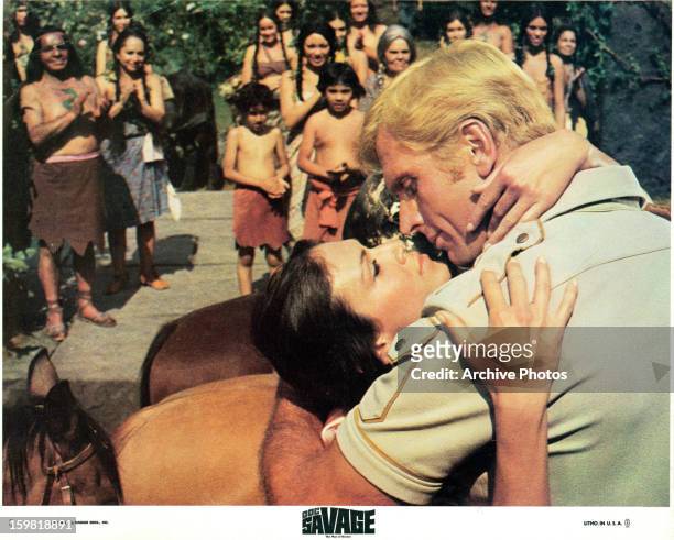 Ron Ely embraces a woman in a scene from the film 'Doc Savage: The Man Of Bronze', 1975.