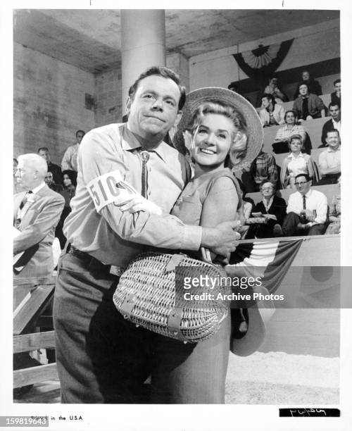 Tom Ewell holds Alice Faye in a scene from the film 'State Fair', 1962.