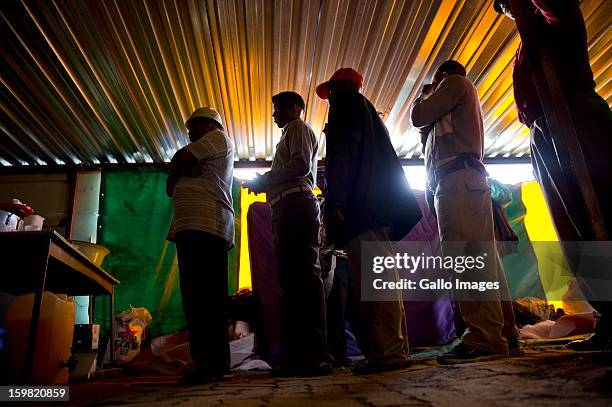 Group of mineworkers waiting for food at a church on January 17, 2013 in Carltonville, South Africa. About 80 miners found themselves stranded and...