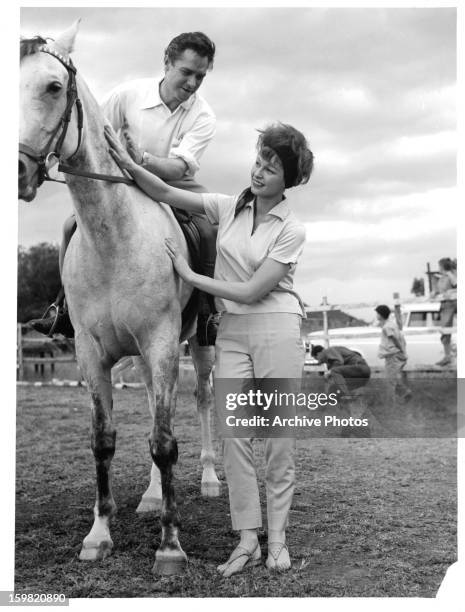 Richard Todd and Anne Aubrey with horse while on location for the film 'The Hellions', 1961.