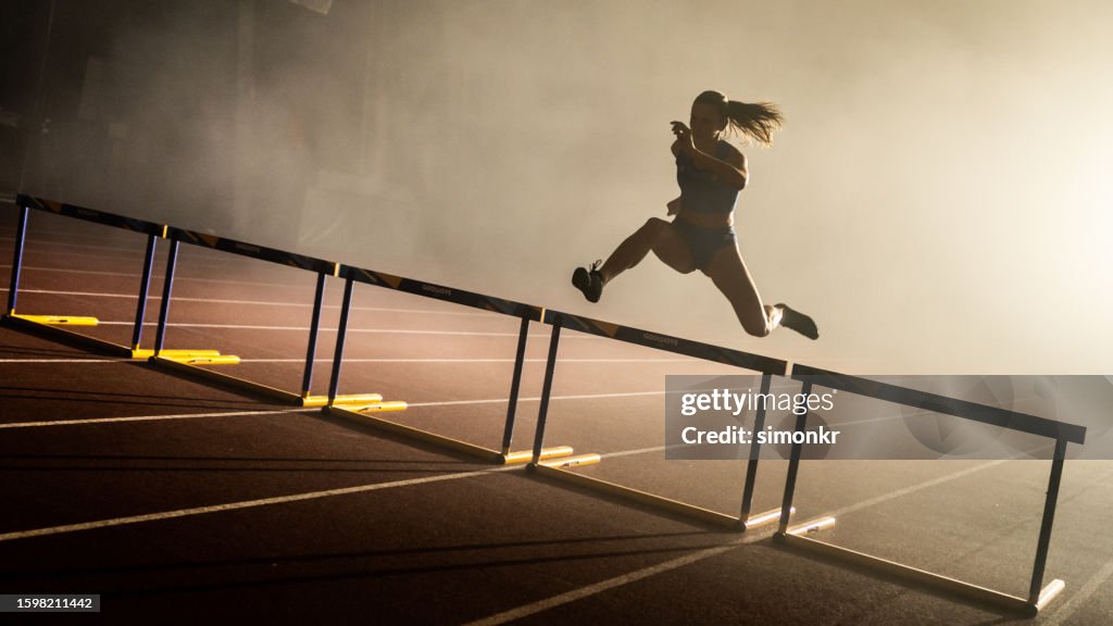 Atleta saltando sobre obstáculo