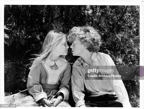 Jodie Foster and Johnny Whitaker about to kiss each other in a scene from the film 'Tom Sawyer', 1973.