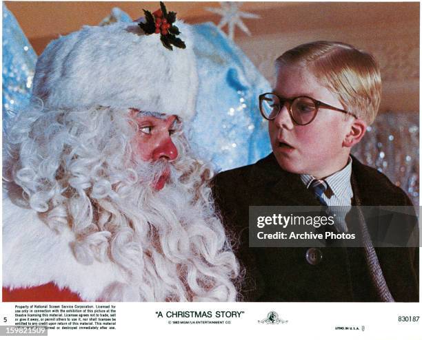 Peter Billingsley sits on Santa's lap in a scene from the film 'A Christmas Story', 1983.