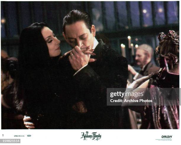 Anjelica Huston is kissed by Raul Julia in a scene from the film 'The Addams Family', 1991.