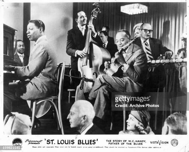 Nat 'King' Cole playing piano in a scene from the film 'St. Louis Blues', 1957.