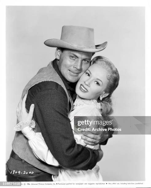 John Agar holds Mamie Van Doren in publicity portrait for the film 'Star In The Dust', 1956.