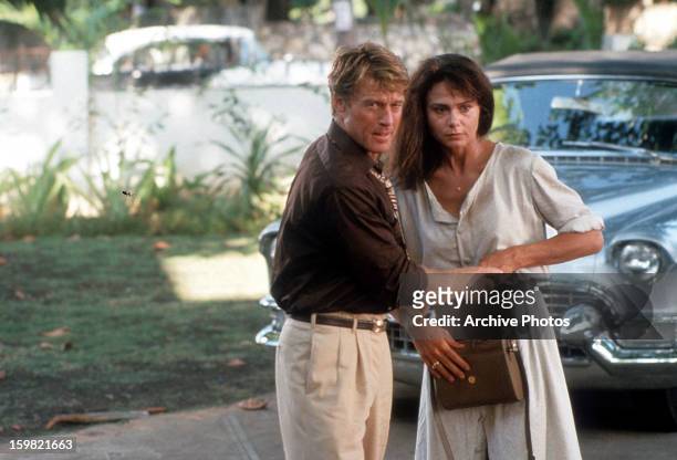 Robert Redford holds the hand of Lena Olin in a scene from the film 'Havana', 1990.