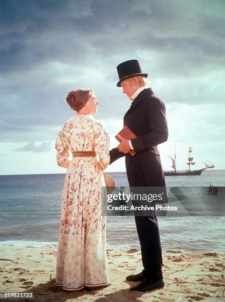 Julie Andrews and Max Von Sydow stand on the beach in a scene from the film 'Hawaii', 1966.