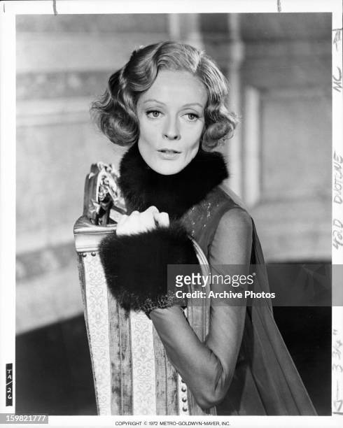 Maggie Smith leaning up on chair in a scene from the film 'Travels With My Aunt', 1972.
