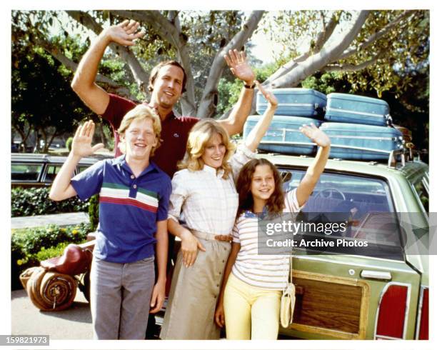 Anthony Michael Hall, Chevy Chase, Beverly D'Angelo, and Dana Barron waving from car in a scene from the film 'Vacation', 1983.