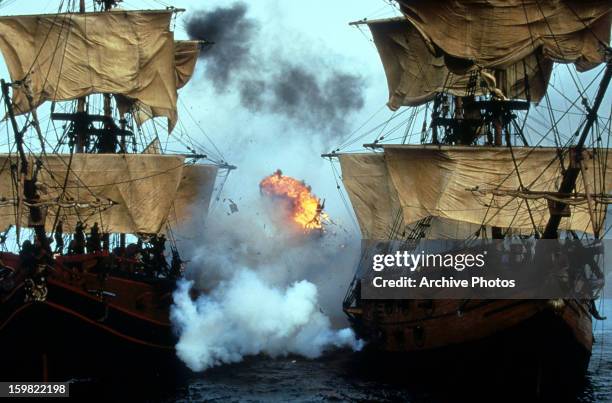 An explosion in between two ships sailing in a scene from the film 'Cutthroat Island', 1995.