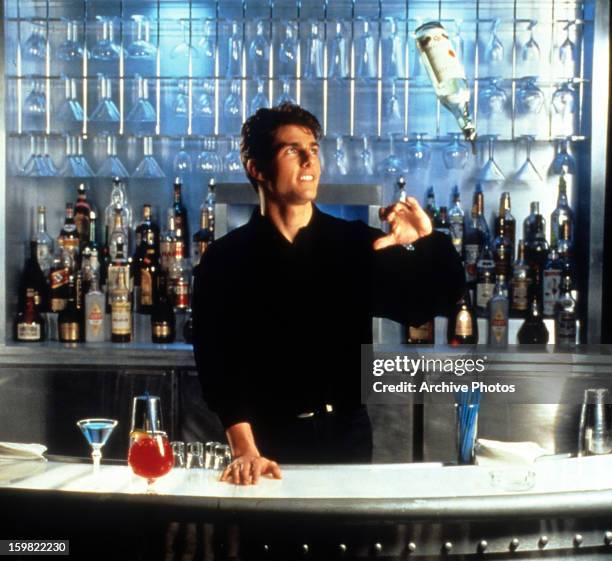 Tom Cruise showing his tricks as a bartender in a scene from the film 'Cocktail', 1988.
