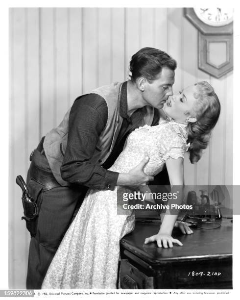 John Agar advances on Mamie Van Doren in a scene from the film 'Star In The Dust', 1956.