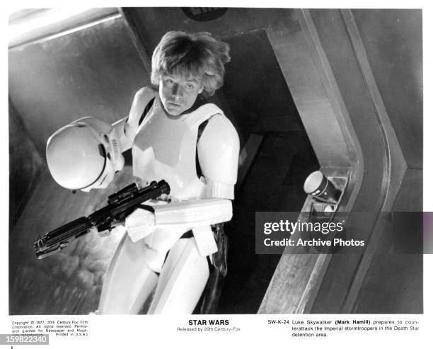 Mark Hamill takes off his storm trooper helmet in a scene from the film 'Star Wars', 1977.